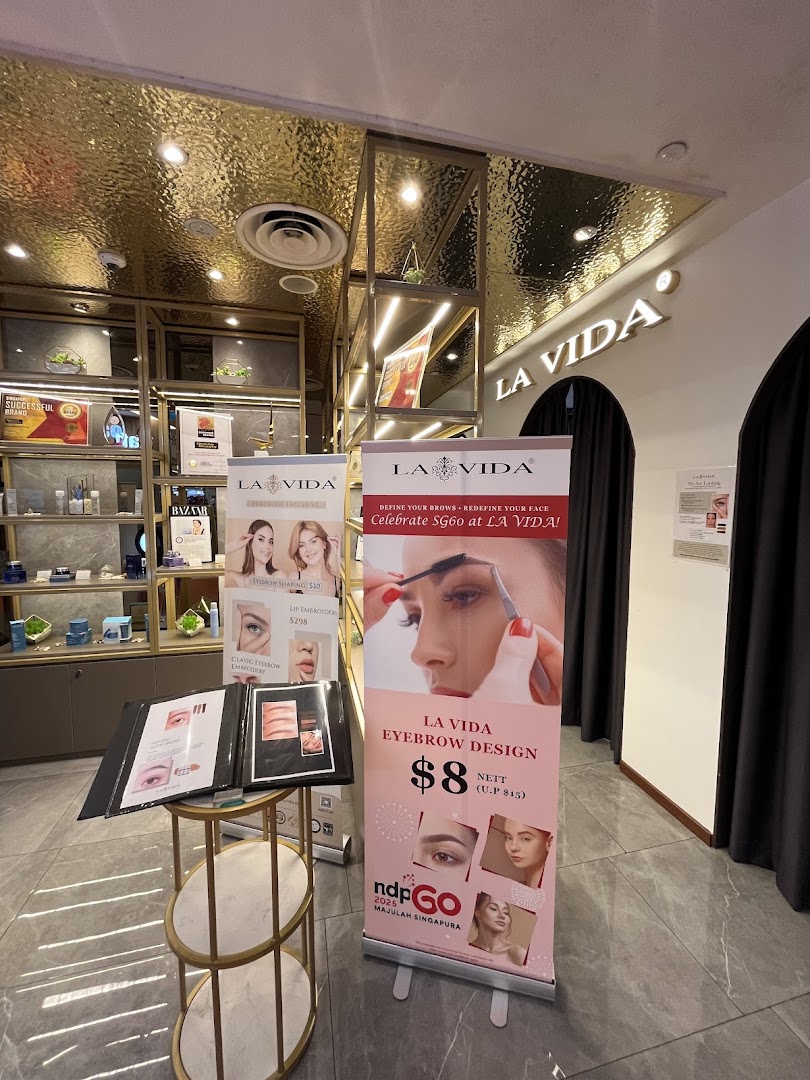 Interior view of La Vida beauty salon, showcasing product displays and eyebrow design promotions.