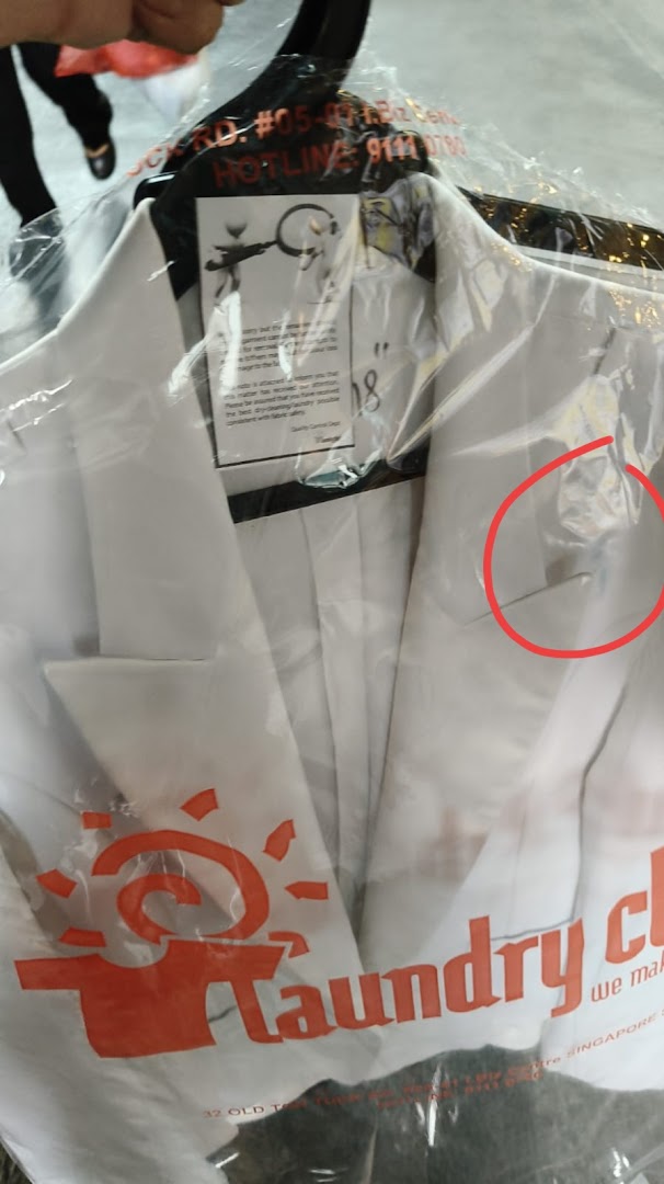 A white jacket, freshly laundered and bagged by Laundry Club, ready for pickup.
