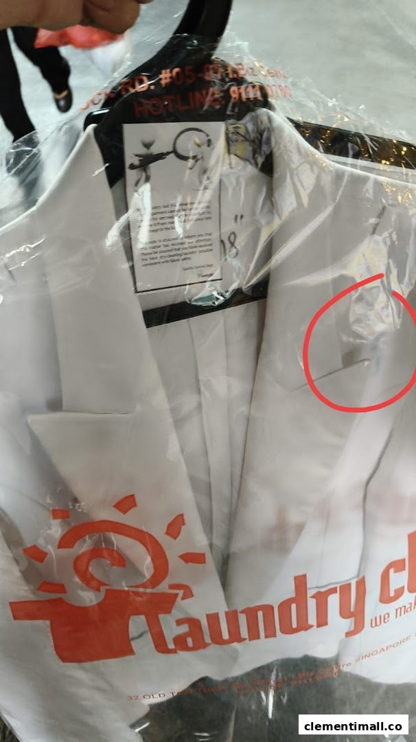 A white jacket, freshly laundered and bagged by Laundry Club, ready for pickup.