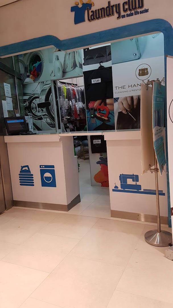 The entrance of Laundry Club, featuring laundry and cleaning service visuals and branding.