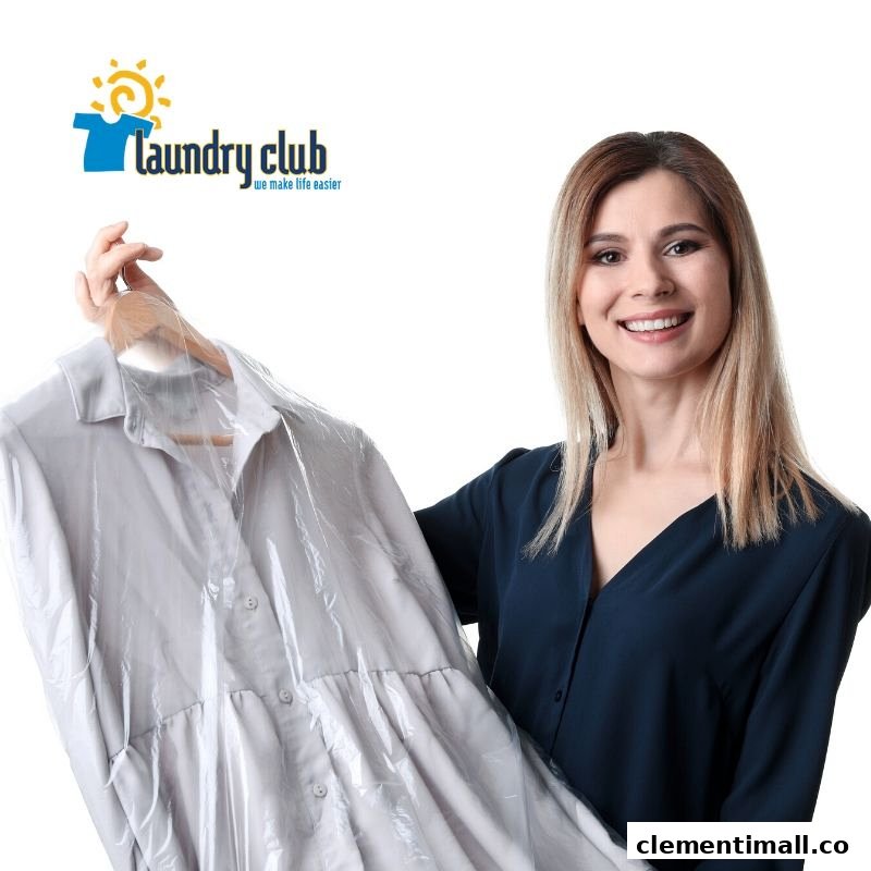 A smiling woman holds a freshly laundered garment from Laundry Club.