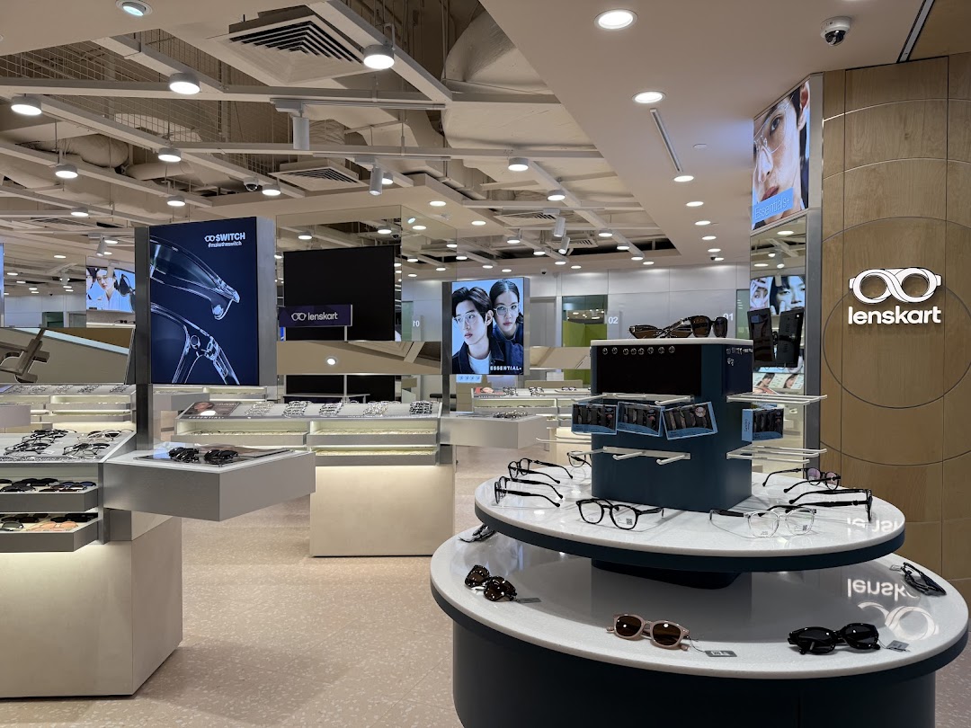 Interior view of Lenskart store showcasing a wide range of eyeglasses and sunglasses on modern display units.