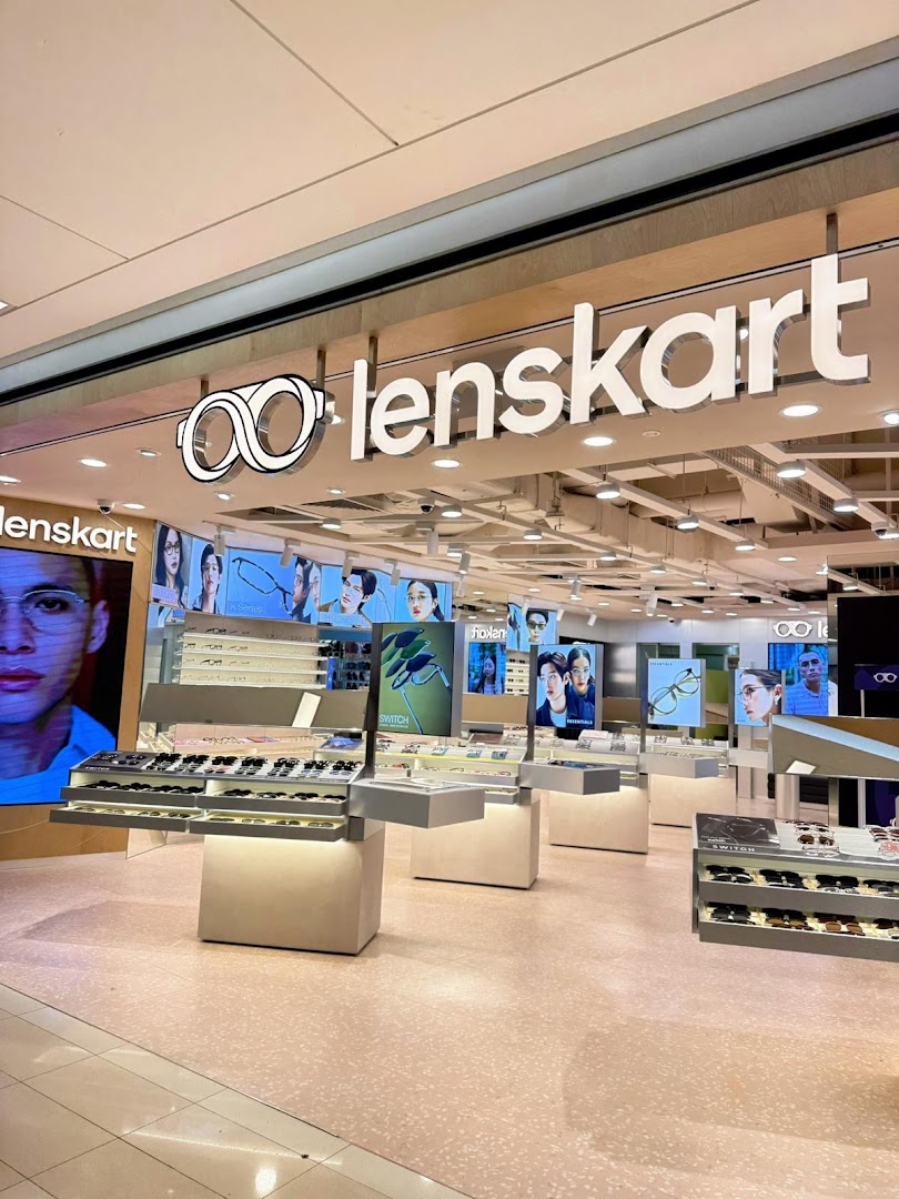 The image shows the brightly lit entrance and interior of the Lenskart store, featuring eyewear displays.