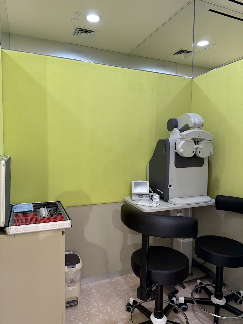 An eye examination room at Lenskart, featuring advanced optical equipment and seating for vision testing.