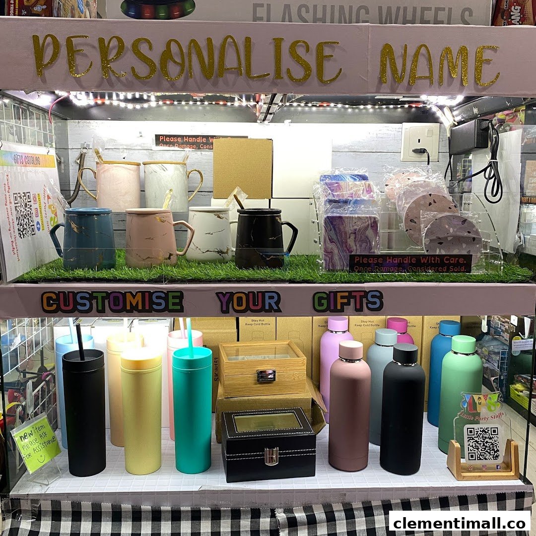 A display of customizable gifts including marble-patterned mugs and colorful insulated bottles.