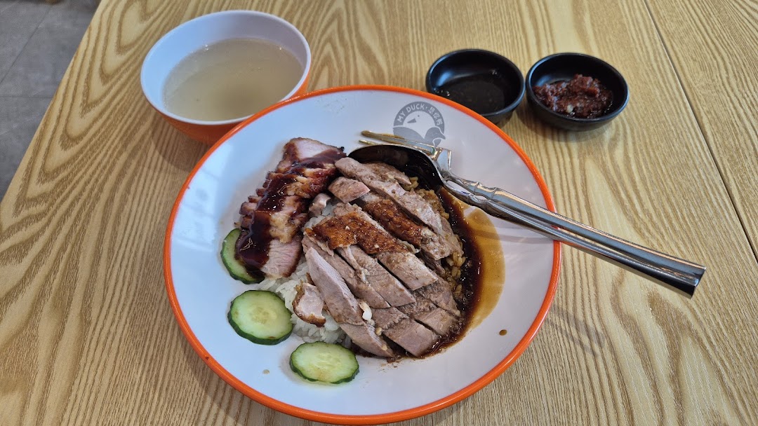 A delicious plate of roasted duck and char siu with rice, soup, and condiments from M.Y Duck.