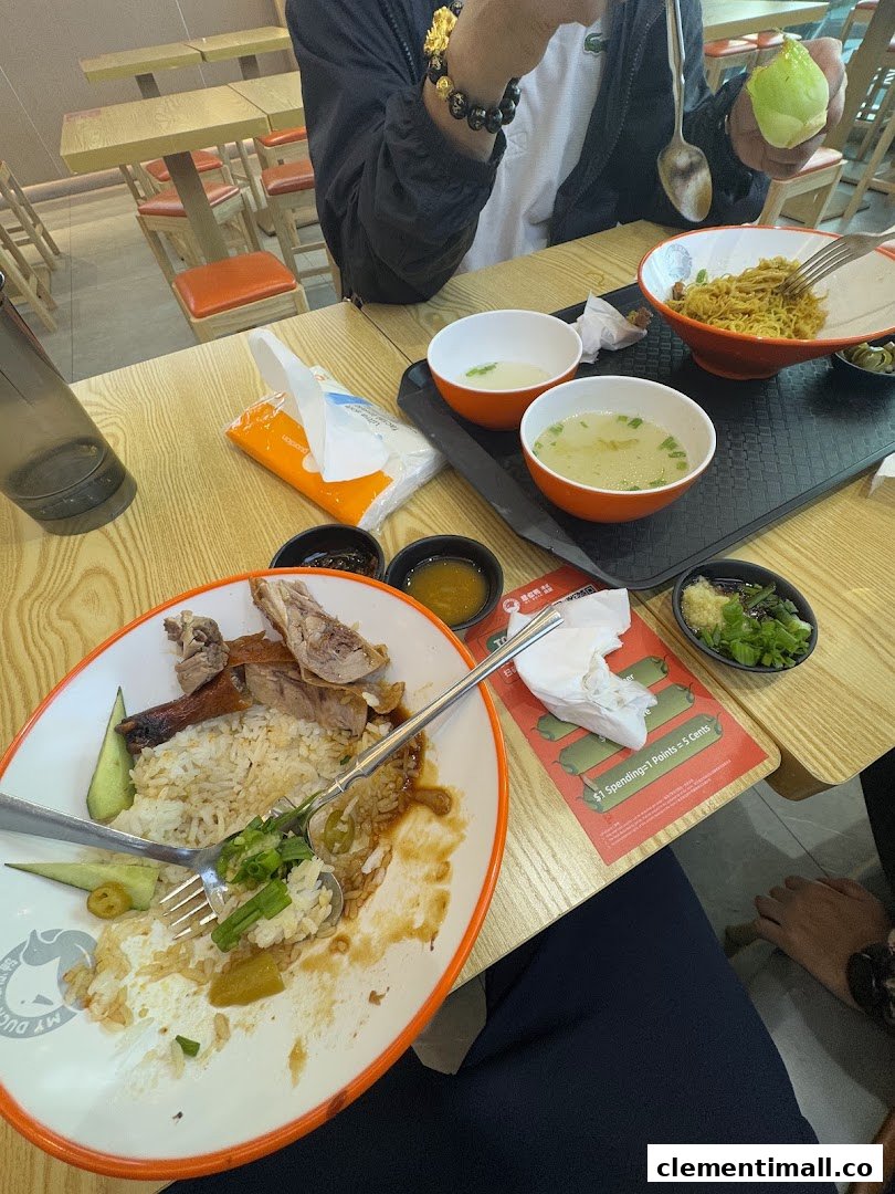 A table with partially eaten duck rice, noodles, and soup at M.Y Duck restaurant.