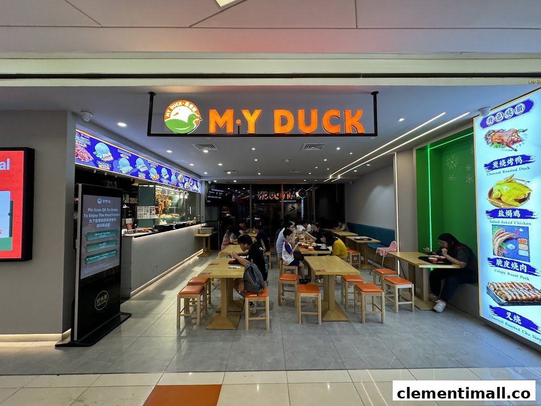 Interior view of M.Y Duck restaurant, showing customers dining, a service counter, and illuminated menu displays.