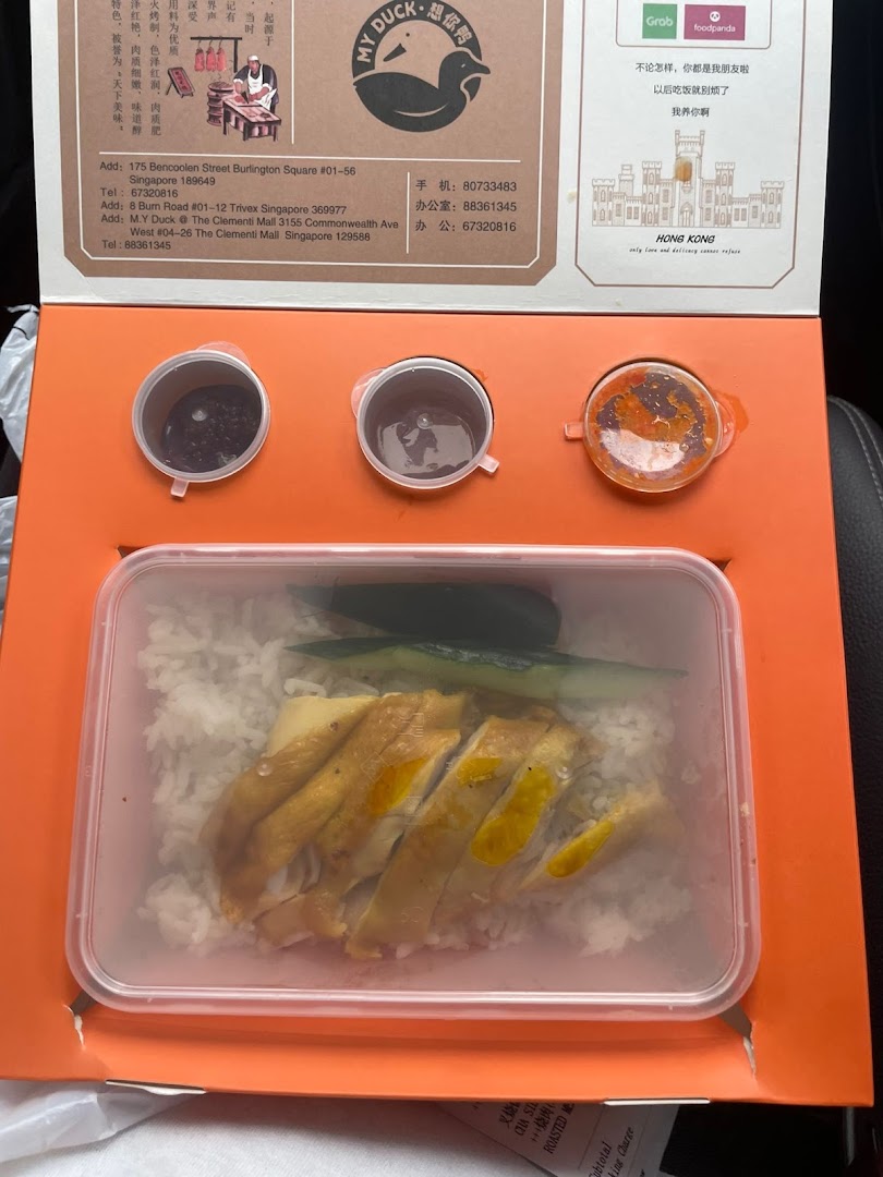 A takeaway box from M.Y Duck featuring roasted chicken rice with sauces.