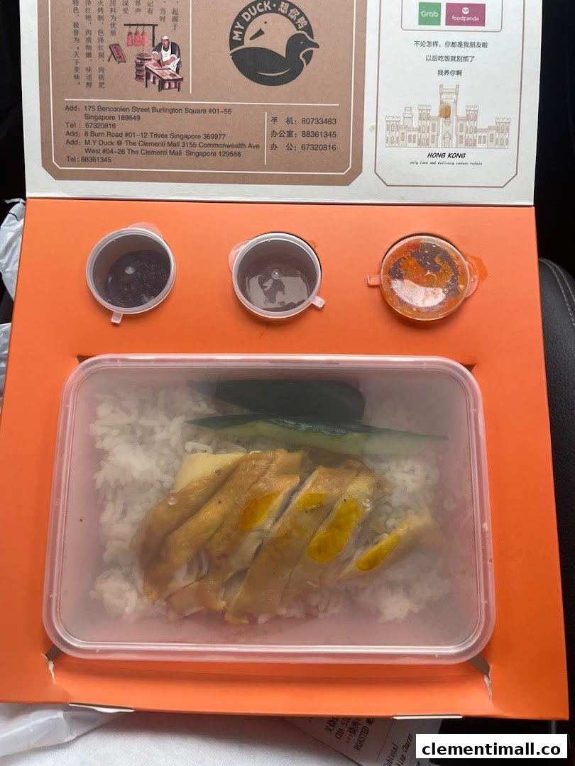 A takeaway box from M.Y Duck featuring roasted chicken rice with sauces.