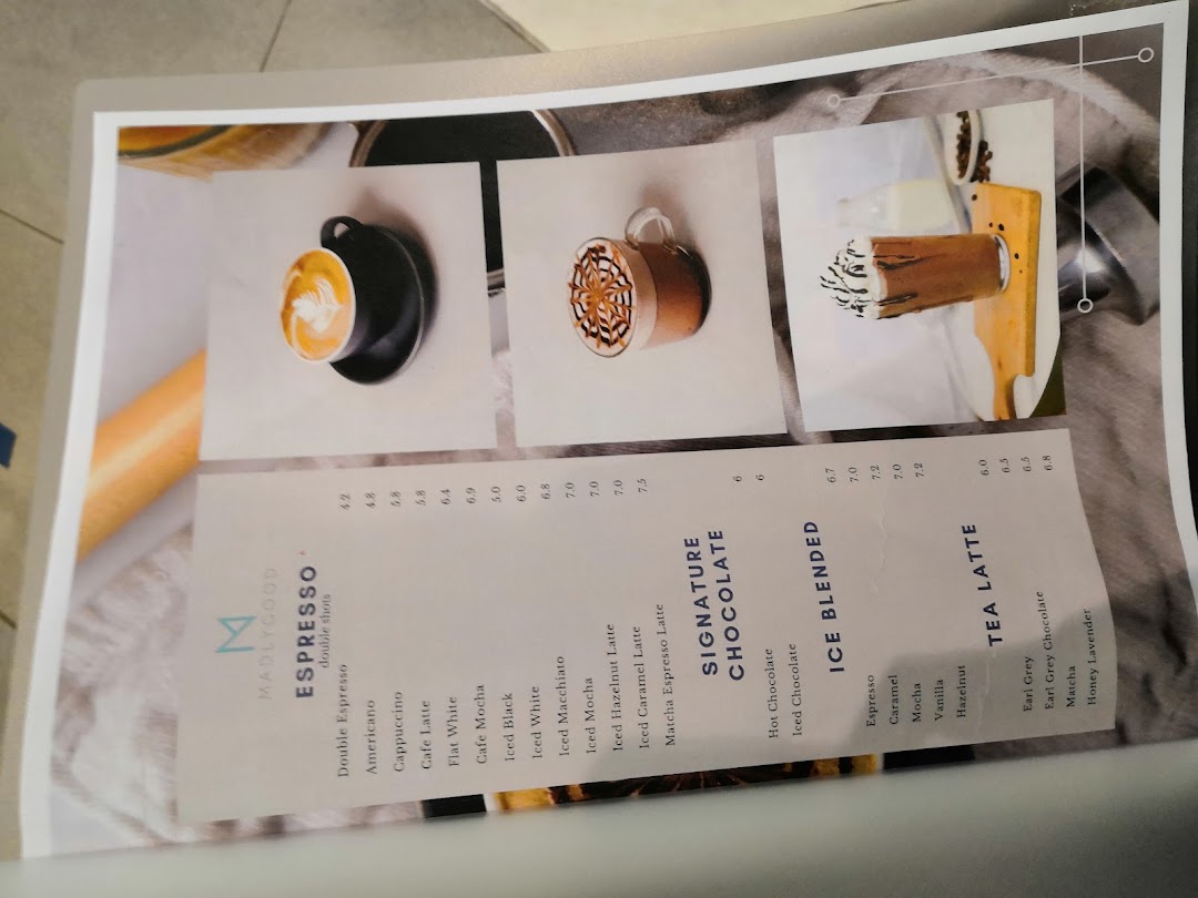 A detailed menu from MADLYGOOD, showcasing various coffee, chocolate, and tea beverages.