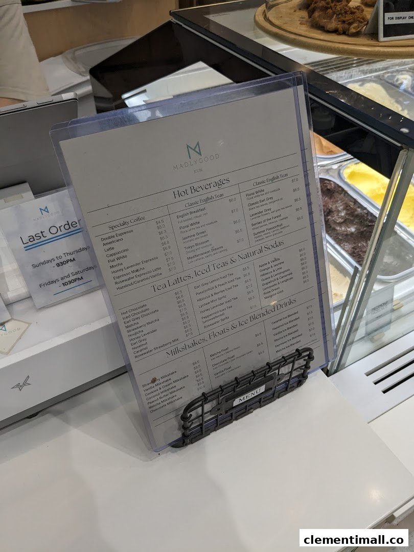 Detailed menu for MADLYGOOD, featuring hot beverages, teas, milkshakes, and floats.