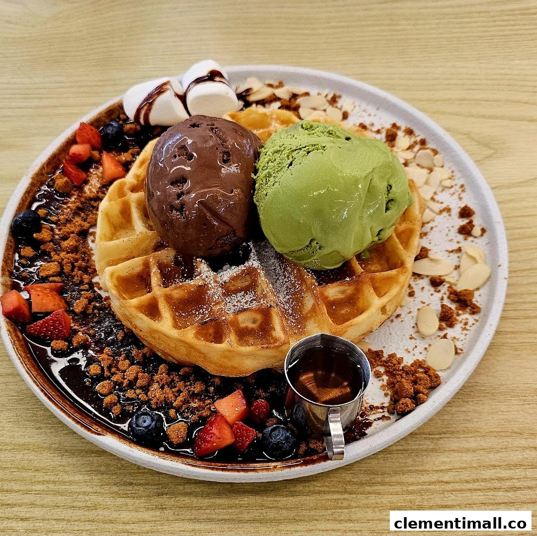 A delicious waffle topped with chocolate and matcha ice cream, berries, nuts, and syrup.