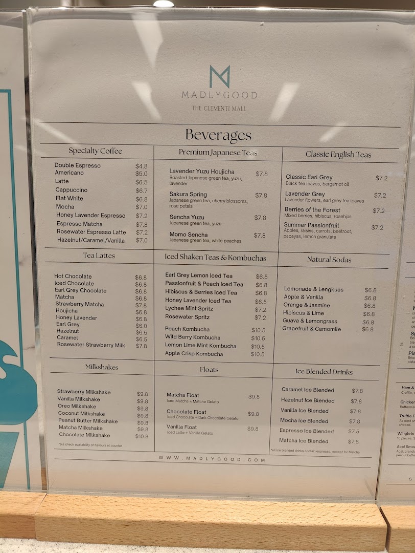 A detailed menu board for MADLYGOOD, showcasing a variety of beverages and desserts.