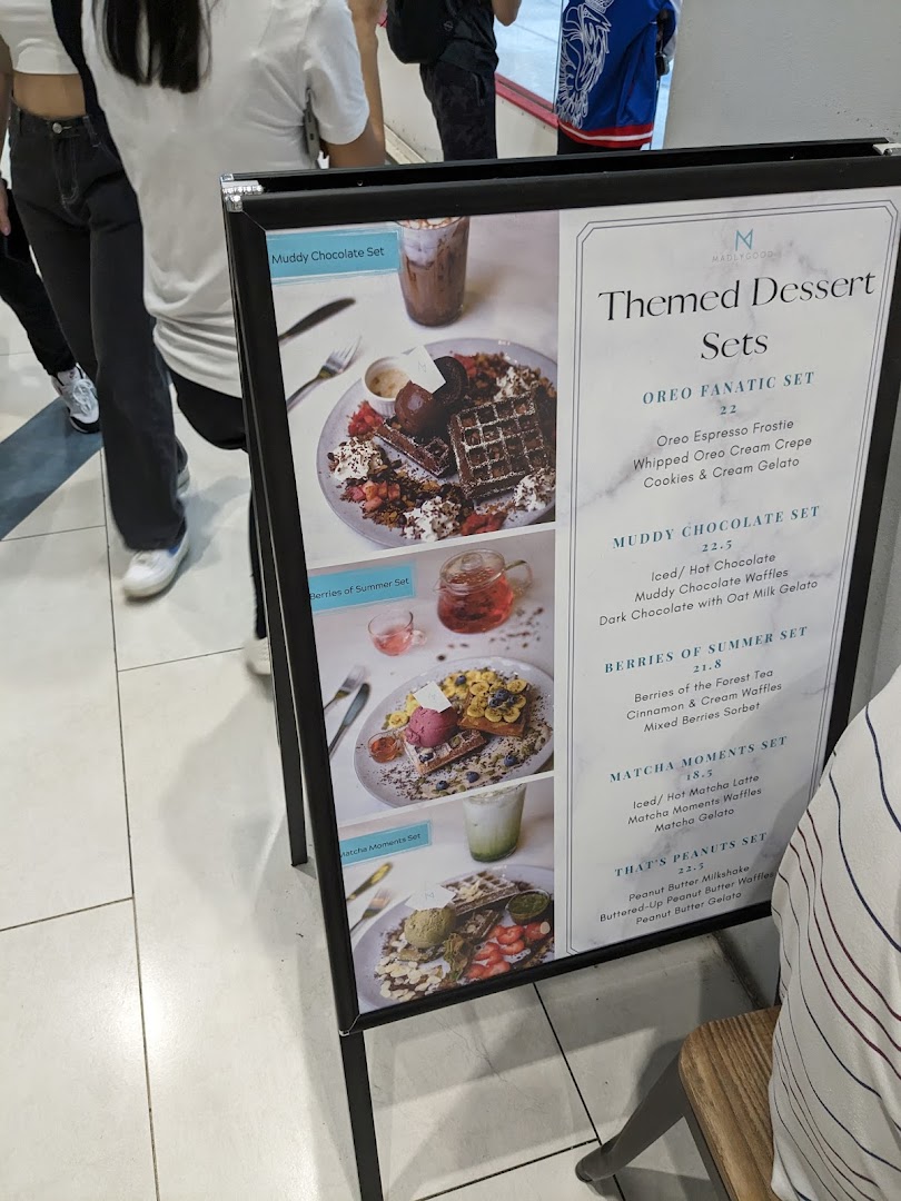 A menu board displaying various themed dessert sets with prices and descriptions.