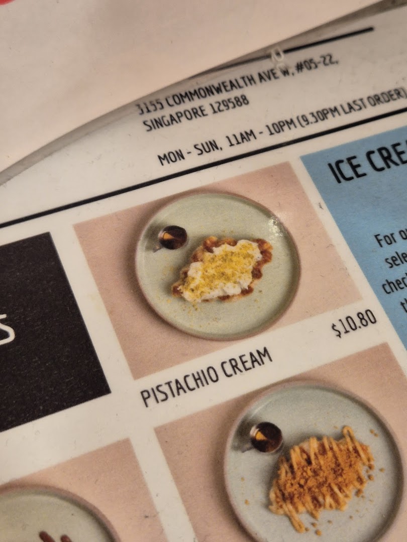 Close-up of MADLYGOOD's menu showing Pistachio Cream dessert, price, address, and operating hours.