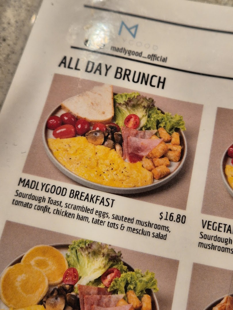 A close-up of MADLYGOOD's menu, showcasing the 'All Day Brunch' section with the 'Madlygood Breakfast' item.