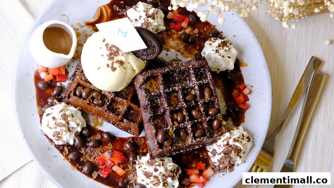 A decadent plate of chocolate waffles topped with ice cream, whipped cream, and various sweet garnishes.