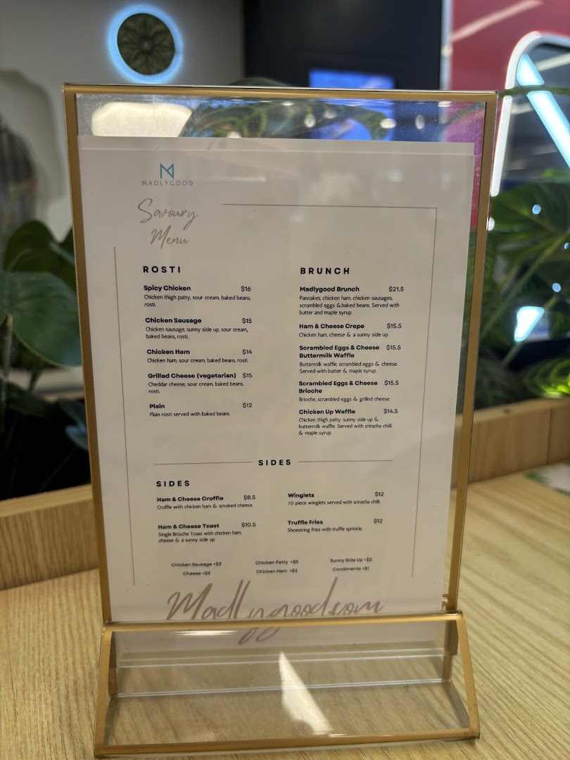 A close-up of MADLYGOOD's Savoury Menu, featuring Rosti, Brunch, and Sides.