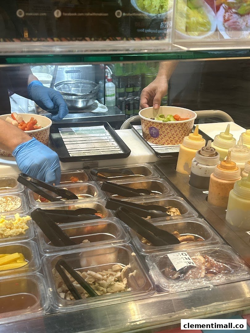 Staff in blue gloves prepare custom sushi/salad bowls with fresh ingredients and sauces at Maki-San.