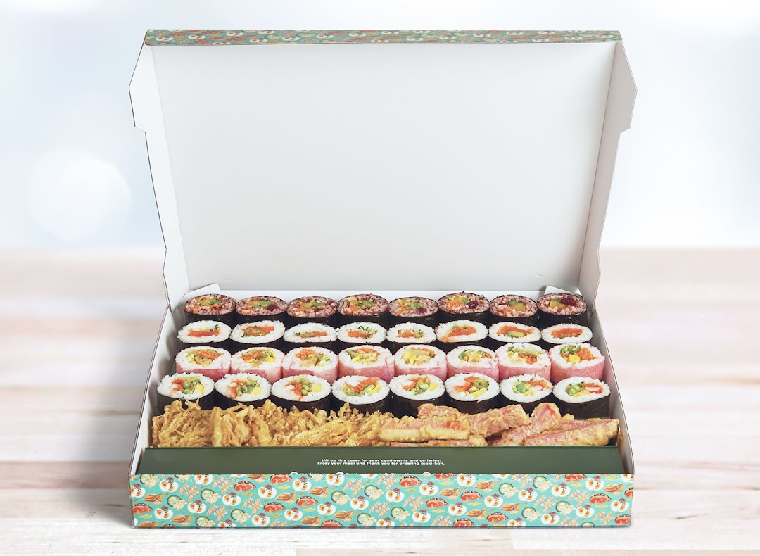 An open Maki-San box filled with assorted sushi rolls and fried tempura items.