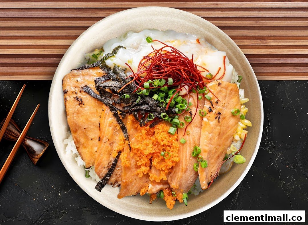 A vibrant bowl of grilled salmon, roe, seaweed, and spring onions over rice, with chopsticks.