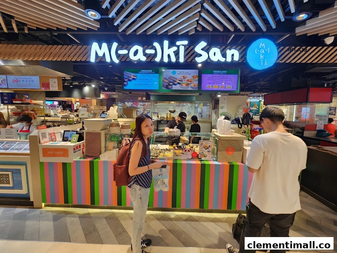 Maki-San's vibrant counter with customers and staff, showcasing their colorful branding and menu screens.