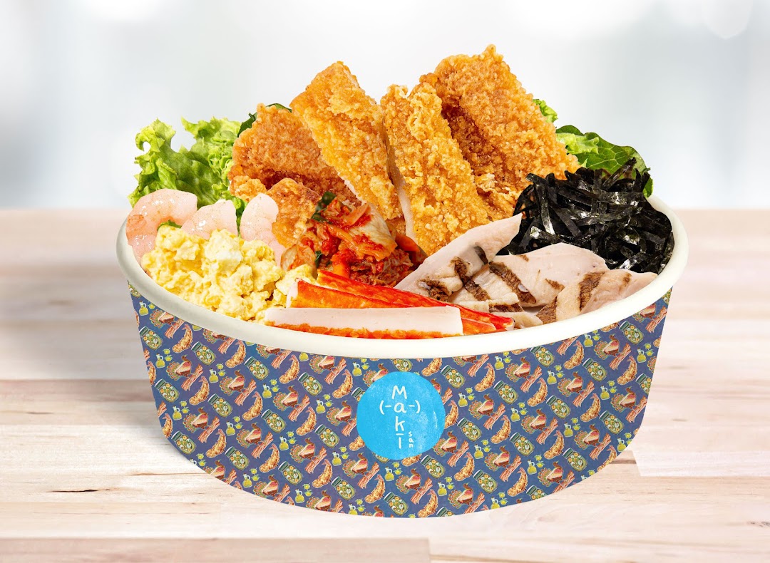A vibrant custom food bowl from Maki-San, featuring fried chicken, shrimp, eggs, kimchi, and other fresh ingredients.