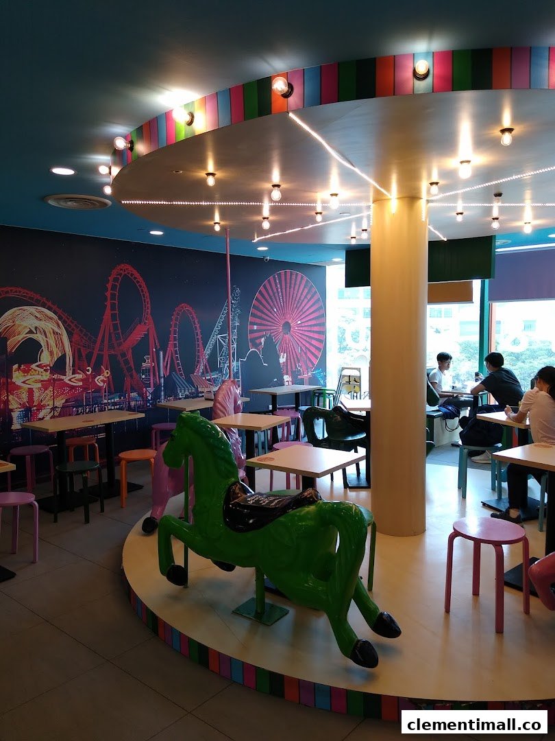 Vibrant interior of Maki-San with a carousel-themed platform, colorful stools, and an amusement park mural.