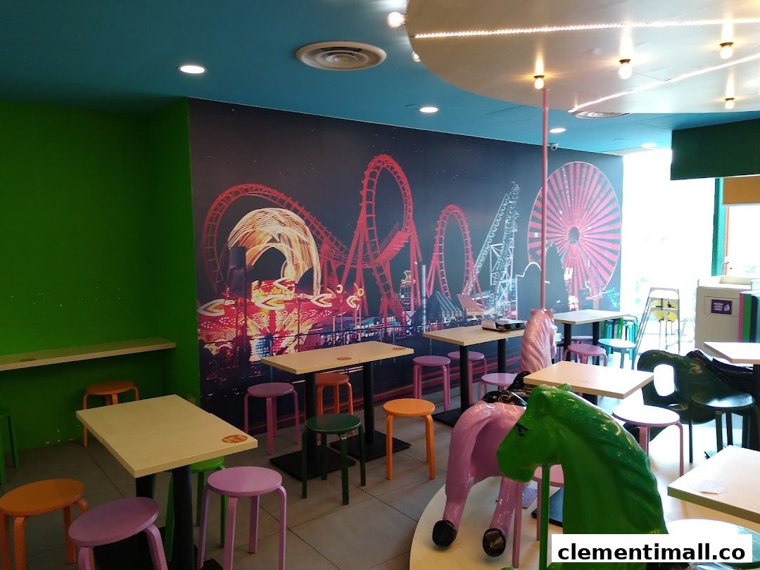 Vibrant interior of Maki-San with colorful stools, tables, and a fun amusement park mural.