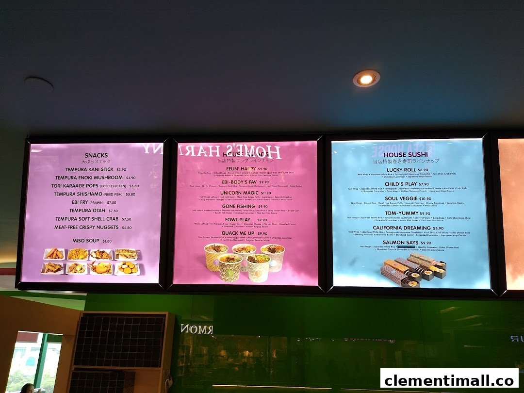 Three illuminated menu boards displaying a variety of snacks, salads, and sushi rolls with prices.