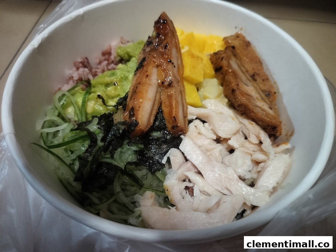 A vibrant custom bowl from Maki-San, featuring grilled chicken, shredded chicken, avocado, cucumber, and fruit.