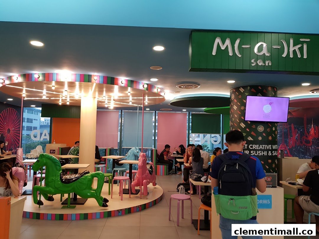 Vibrant interior of Maki-San featuring carousel-themed seating, colorful decor, and customers dining.
