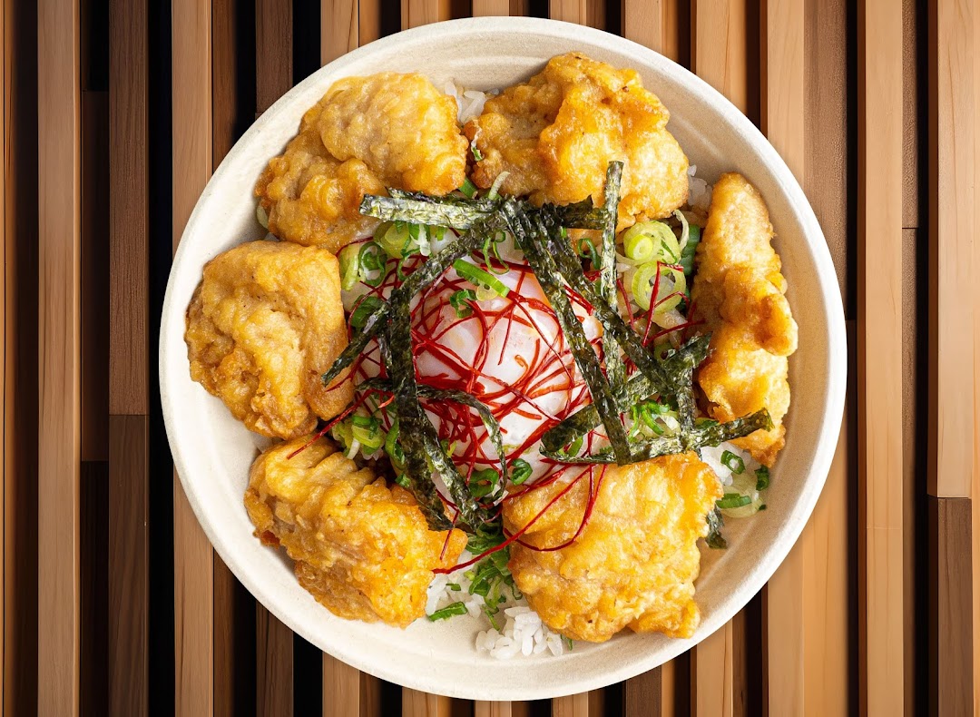 A delicious bowl of fried chicken, rice, egg, and toppings from Maki-San.