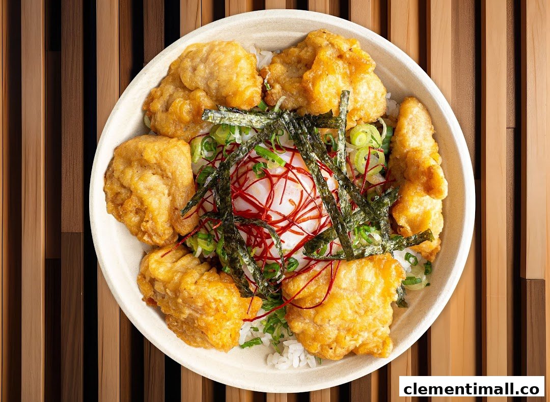 A delicious bowl of fried chicken, rice, egg, and toppings from Maki-San.