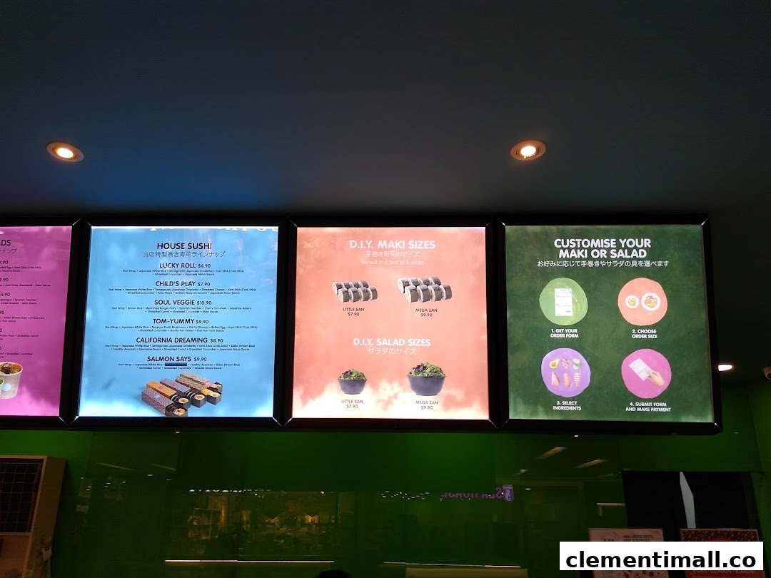 Brightly lit menu boards display Maki-San's customisable sushi and salad options with prices.