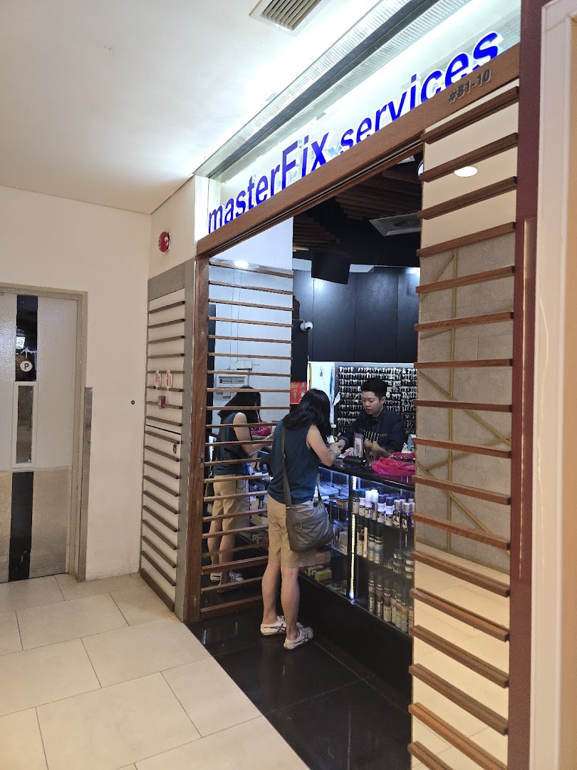 The image shows the brightly lit entrance of MasterFix services with a customer at the counter.