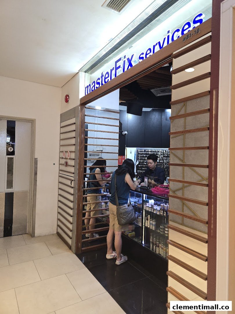The image shows the brightly lit entrance of MasterFix services with a customer at the counter.