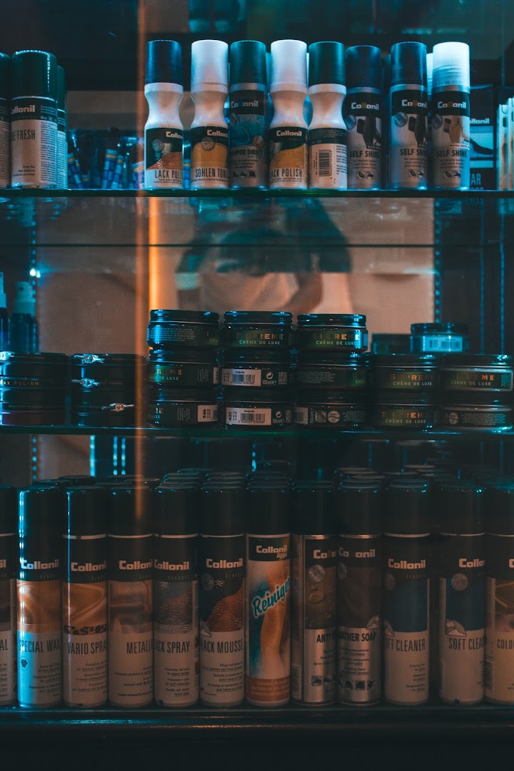 Shelves displaying a wide range of shoe care products, including polishes, sprays, and creams.