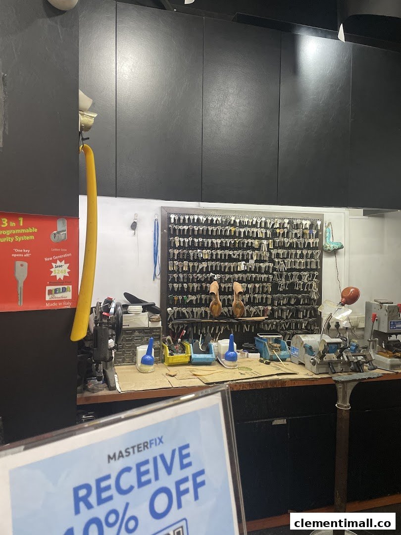 Interior view of MasterFix, a key duplication and repair shop, showcasing tools and a wall of key blanks.