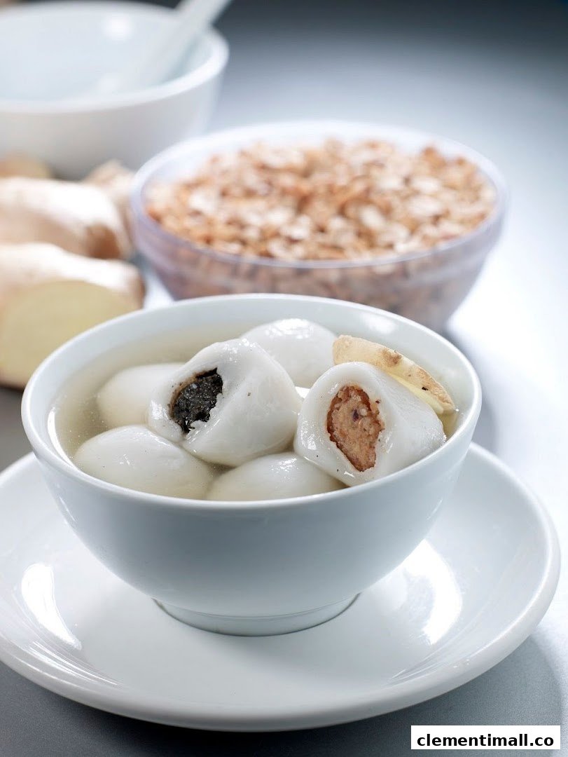 A bowl of traditional glutinous rice balls (tangyuan) with various fillings in ginger soup.