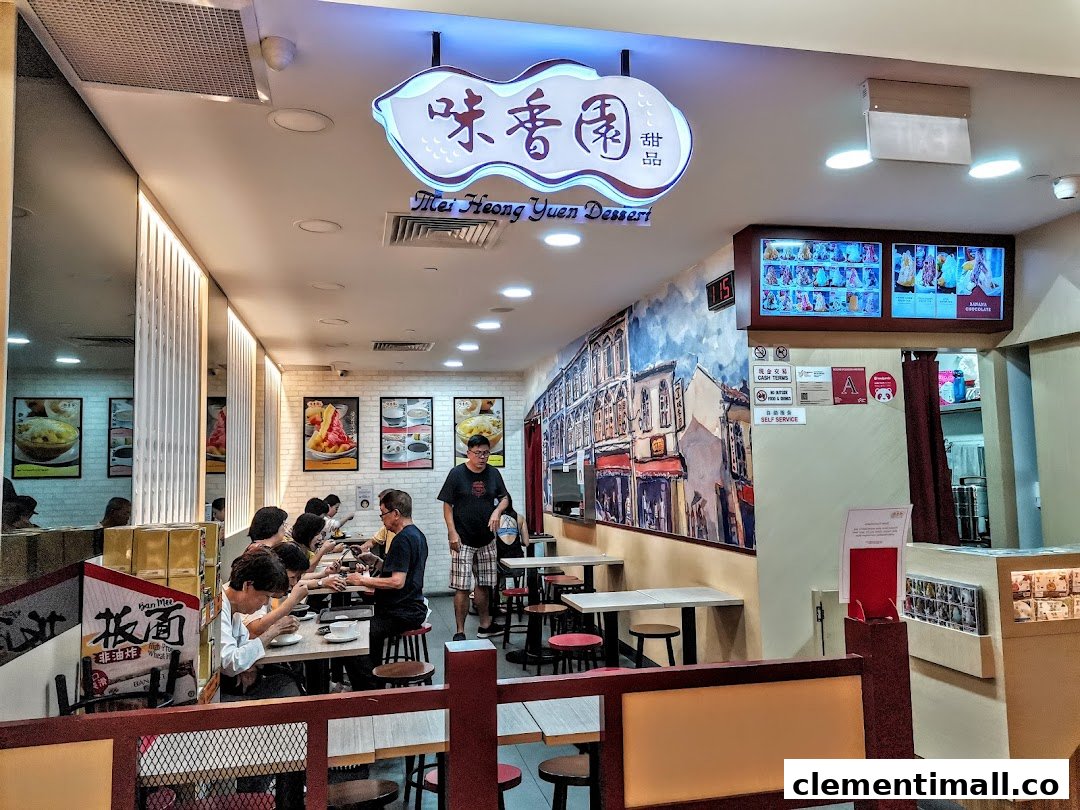 Customers enjoy traditional desserts in the vibrant interior of Mei Heong Yuen Dessert, featuring a charming mural.
