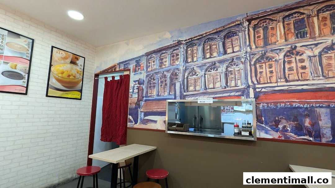 Interior view of Mei Heong Yuen Dessert, featuring a vibrant mural, cozy seating, and dessert posters.