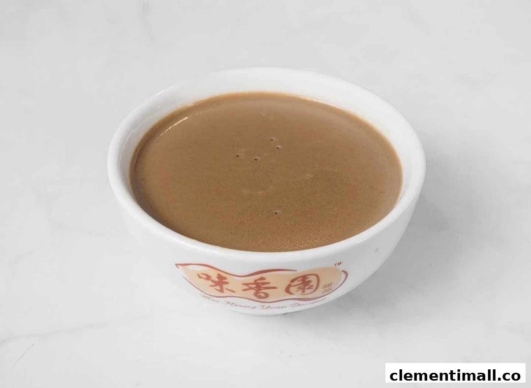 A close-up of a bowl of traditional brown dessert, likely sesame or peanut paste, from Mei Heong Yuen.