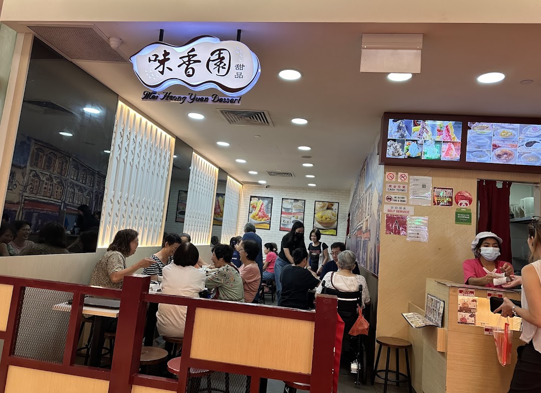 Bustling interior of Mei Heong Yuen Dessert, showing customers enjoying treats and staff at the counter.