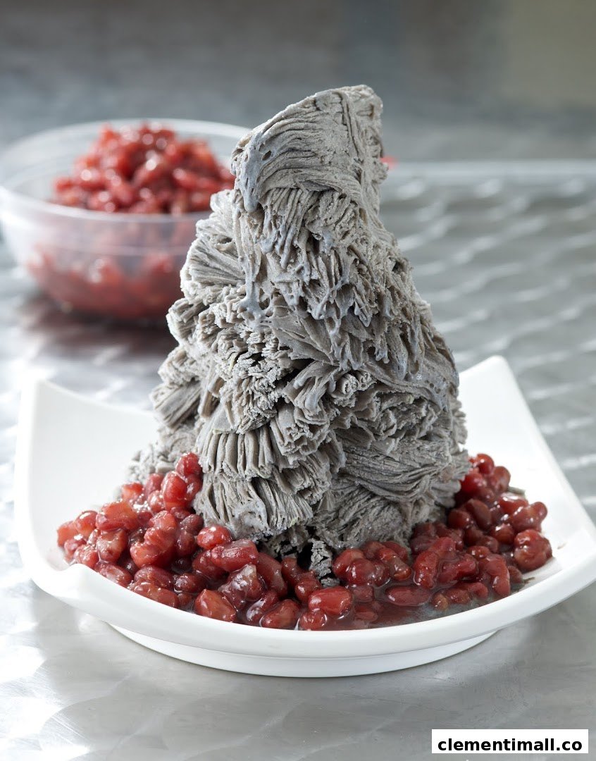 A towering black sesame shaved ice dessert served with sweet red beans.