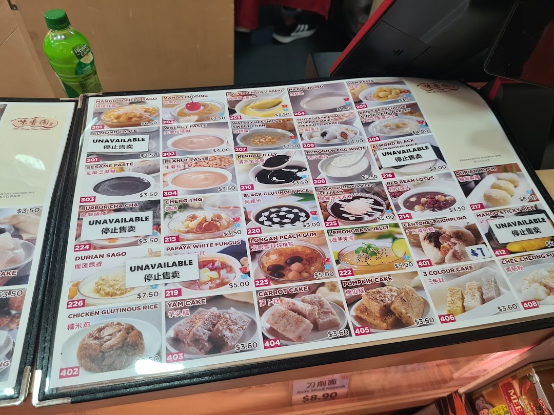 A detailed menu board displaying various traditional Asian desserts and snacks with prices.