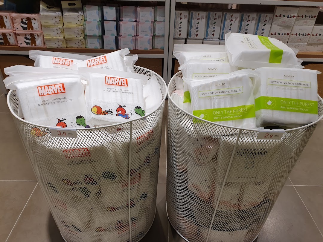Two bins display MINISO and Marvel cotton pads with prices in a retail store.