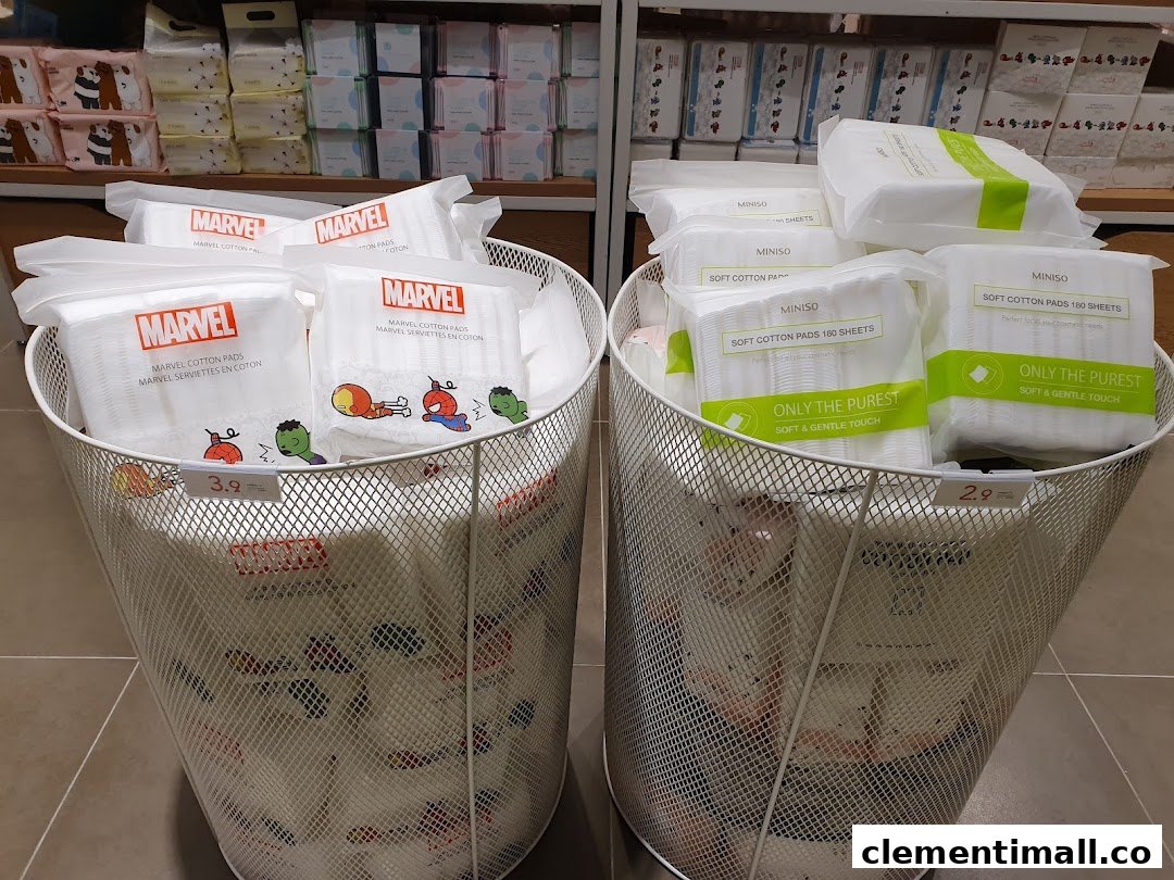 Two bins display MINISO and Marvel cotton pads with prices in a retail store.