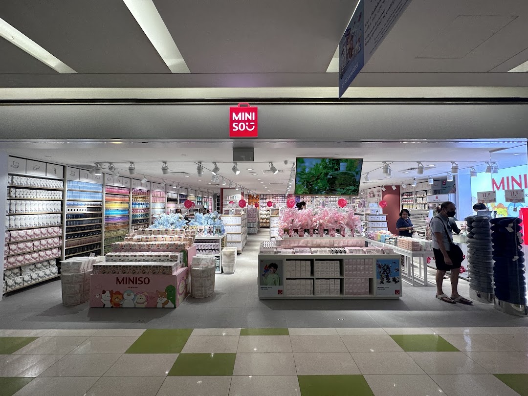 The MINISO store entrance at Clementi Mall, showcasing a wide array of colorful products and displays.